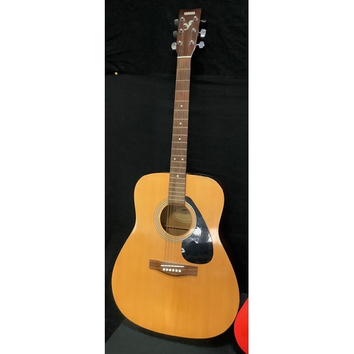 205 - A Yamaha F-310 six string acoustic guitar;  Mahalo U30G red Ukulele;  a childs Palma PJROFT guitar, ... 