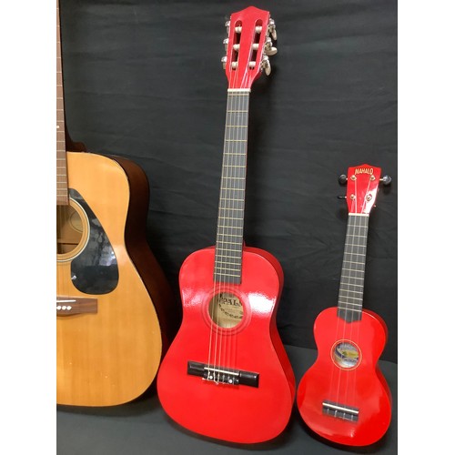 205 - A Yamaha F-310 six string acoustic guitar;  Mahalo U30G red Ukulele;  a childs Palma PJROFT guitar, ... 