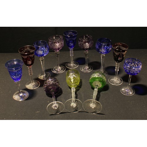 140 - A pair of amethyst flashed hock glasses, engraved with opaque fruiting vine, slender tapering stems,... 