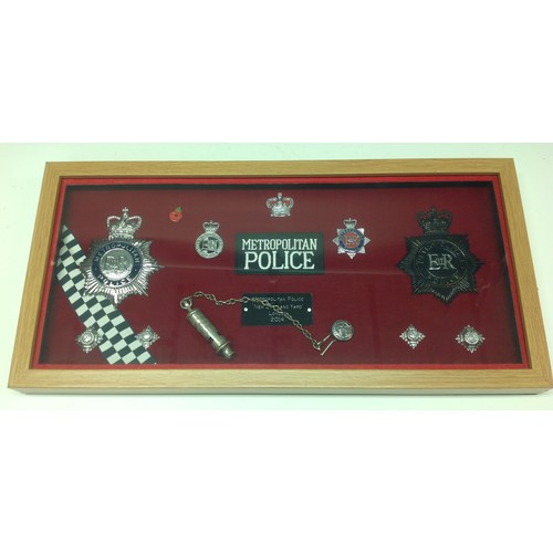 202 - Framed display of Metropolitan Police badges to include two helmet plates (Both Queens Crown) , two ... 