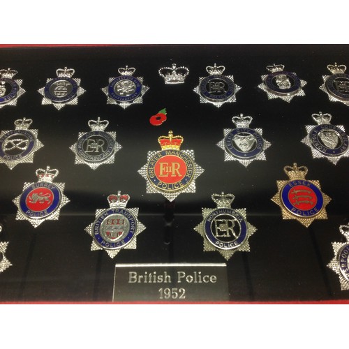 203 - A collection of framed British Police cap badges entitled 