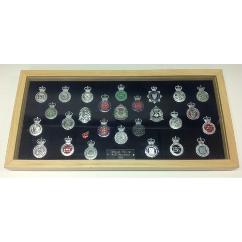 204 - A collection of framed British Police cap badges entitled 