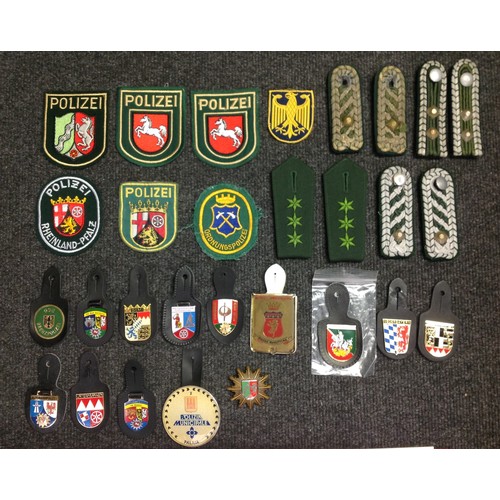 214 - West German Police insignia comprising of sleeve insignia, 13 pocket fob insignias, shoulder boards ... 