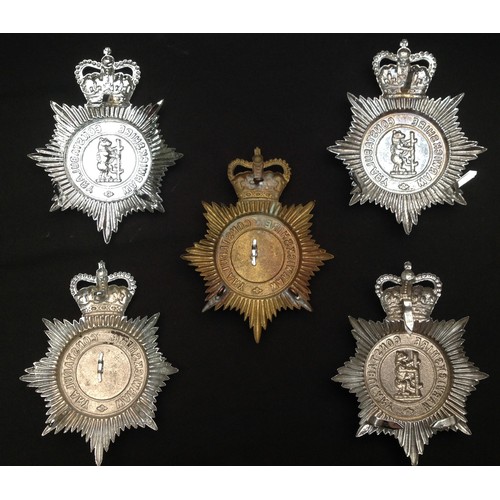 223 - A collection of 5 ERII Warwickshire Constabulary Helmet Plates; one night plate, two enameled plates... 