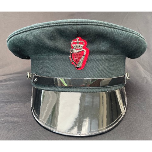 328 - Royal Ulster Constabulary Officers Peaked Caps x 2. Both complete with Queens Crown cap badge and ch... 