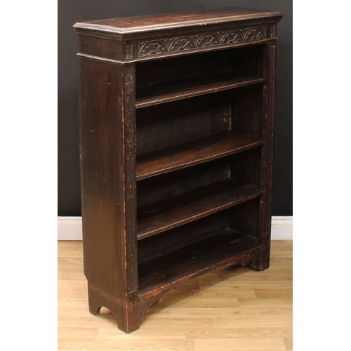 111 - A late Victorian ebonised oak open bookcase, carved with scrolling acanthus and floral lunettes, 114... 