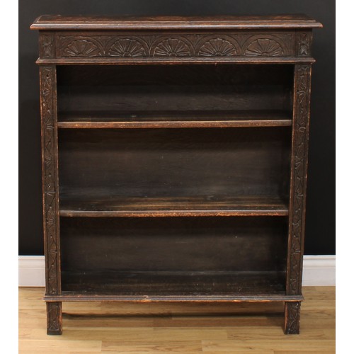 111 - A late Victorian ebonised oak open bookcase, carved with scrolling acanthus and floral lunettes, 114... 