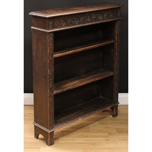 111 - A late Victorian ebonised oak open bookcase, carved with scrolling acanthus and floral lunettes, 114... 