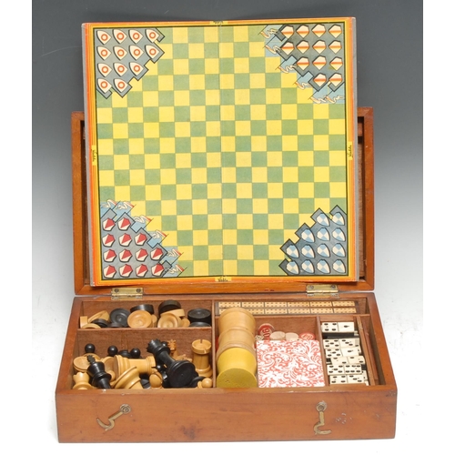 3347 - An Edwardian mahogany games compendium, hinged cover enclosing an arrangement of chess and other pla... 