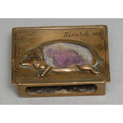 3318 - An early 20th century brass novelty vesta matchbox sleeve, the striker as a pig, inscribed Scratch M... 