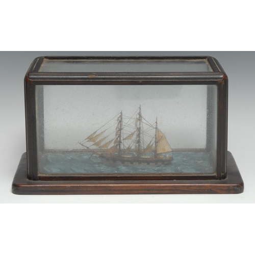 3328 - An early 20th century folk art maritime model, of a sailing ship on a choppy sea, rectangular glazed... 