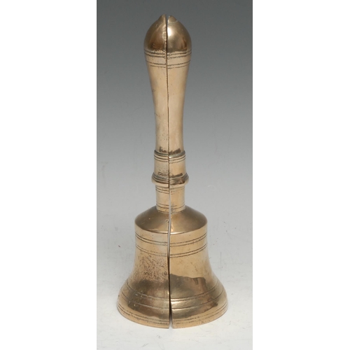 3225 - A pair of brass book ends or door stops, cast as a bisected bell, 23cm high