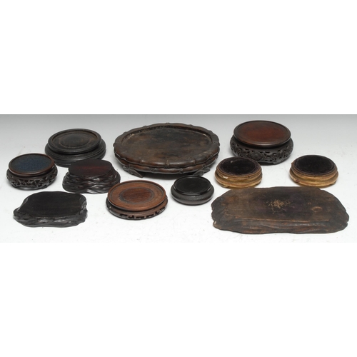 3102 - A Chinese hardwood connoisseur's stand, the shaped top with shallow gallery, pierced and boldly carv... 