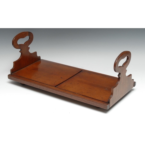 3344 - An early Victorian mahogany book carrier, each shaped sliding end with pierced carrying handle, 51cm... 