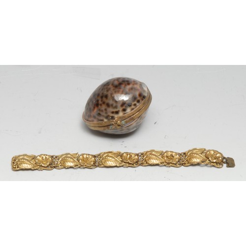 3325 - An early 20th century cowrie shell purse, 7cm wifde; a gilt metal bracelet (2)