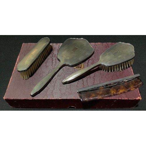 92 - A silver four piece dressing table set, boxed, Birmingham 1951