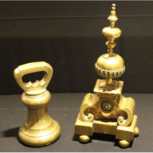 137 - A brass bell shaped weight, to weigh 1000 sovereigns, 24cm; a 19th brass fire dog, 41.5cm (2)