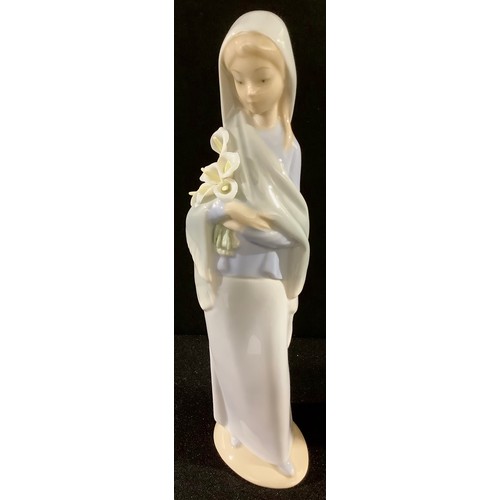 165 - A Lladro figure, girl holding a bunch of lilies, 23cm high