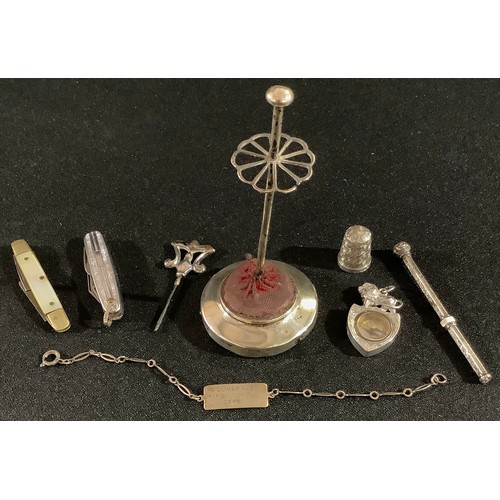 186 - A silver compass fob, Birmingham 1897; a silver hat pin terminal; a silver hat pin stand; a silver t... 