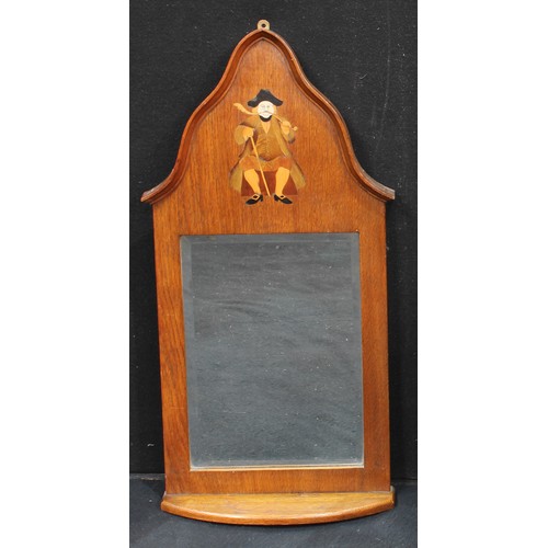 198 - An Arts and Crafts oak wall mirror with shelf, inlaid with man smoking a churchwarden's pipe, bevell... 