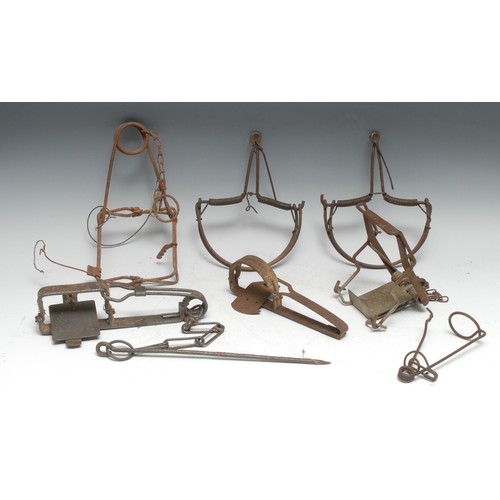 3407 - Gamekeeping - a 19th century gin trap, by C Homes, 26cm long; another, egg shaped jaws, 23cm long; a... 