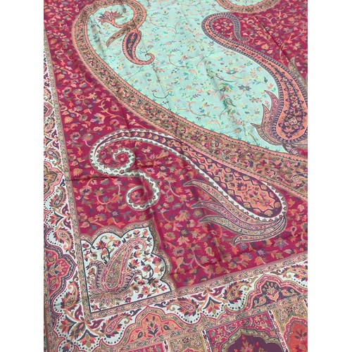 482 - Textiles - a large Paisley shawl in shades of pink, orange and taupe, approximately 220cm x 100cm