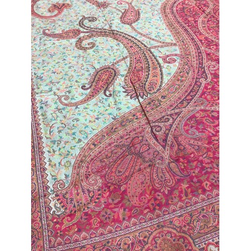 483 - Textiles - a Paisley shawl, brightly embroidered in shades of pink, orange, ochre and green, approx.... 