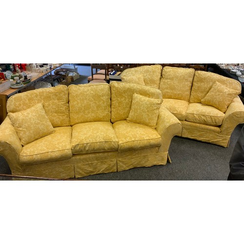 193 - A Pair of three seat sofas, golden yellow floral upholstery, each measuring 232cm wide x 91cm depth ... 