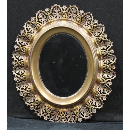 591 - Interior Design - an oval wall mirror, the frame consisting of removalble coronet shaped pierced bra... 