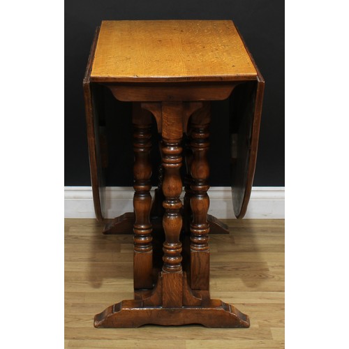 108 - A 17th century style oak gateleg dining table, oval top with fall leaves, turned supports, trestle s... 