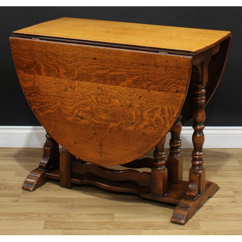 108 - A 17th century style oak gateleg dining table, oval top with fall leaves, turned supports, trestle s... 