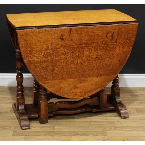 108 - A 17th century style oak gateleg dining table, oval top with fall leaves, turned supports, trestle s... 