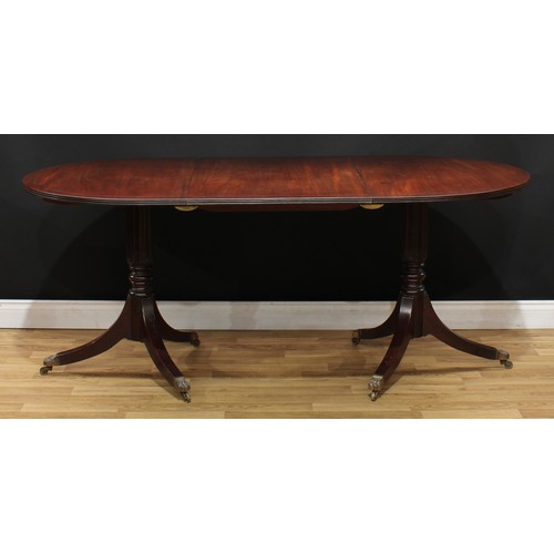 115 - A Regency style mahogany twin pillar dining table, 74.5cm high, 123cm extending to 183cm long, 91.5c... 