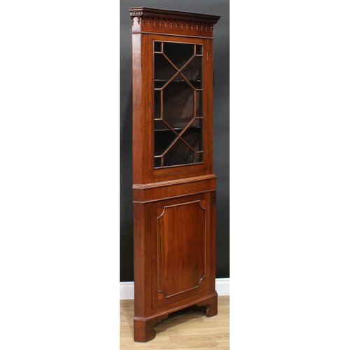 116 - A George III Revival mahogany floor standing corner display cabinet, dentil cornice above a glazed d... 