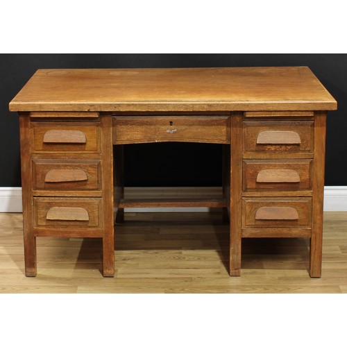 202 - A mid-20th century oak and veneer desk, rectangular top above a pair of slides and an arrangement of... 