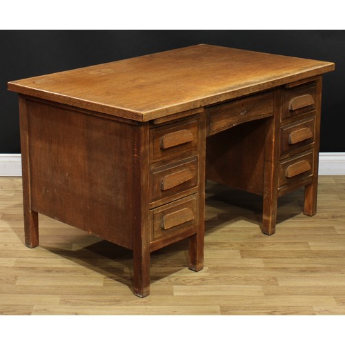 202 - A mid-20th century oak and veneer desk, rectangular top above a pair of slides and an arrangement of... 