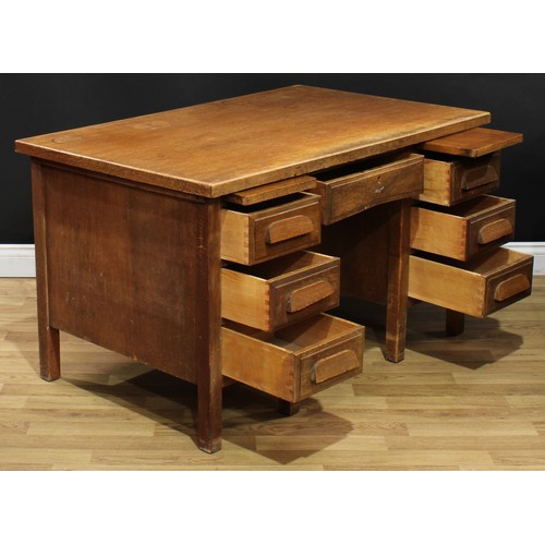 202 - A mid-20th century oak and veneer desk, rectangular top above a pair of slides and an arrangement of... 