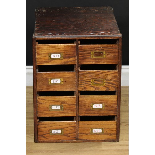 202 - A mid-20th century oak and veneer desk, rectangular top above a pair of slides and an arrangement of... 