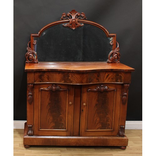 210 - A Victorian mahogany chiffonier, the mirror frame carved and applied with scrolling leaves, serpenti... 