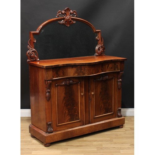 210 - A Victorian mahogany chiffonier, the mirror frame carved and applied with scrolling leaves, serpenti... 