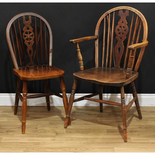 220 - A set of sixteen wheelback Windsor type dining chairs, 90.5cm high, 40.5cm wide, the seat 37cm wide ... 