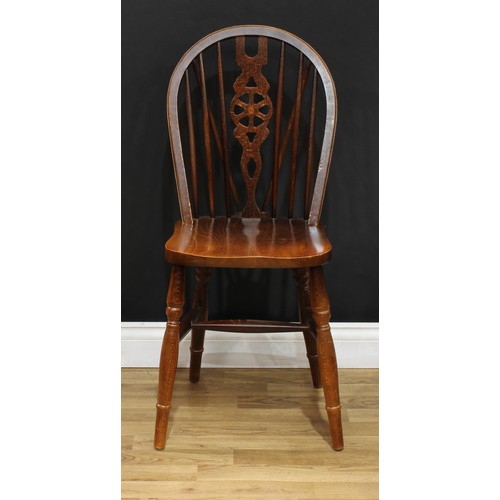 220 - A set of sixteen wheelback Windsor type dining chairs, 90.5cm high, 40.5cm wide, the seat 37cm wide ... 