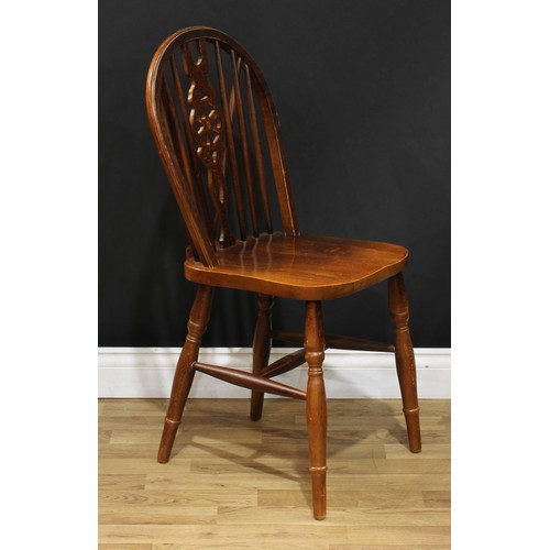 220 - A set of sixteen wheelback Windsor type dining chairs, 90.5cm high, 40.5cm wide, the seat 37cm wide ... 