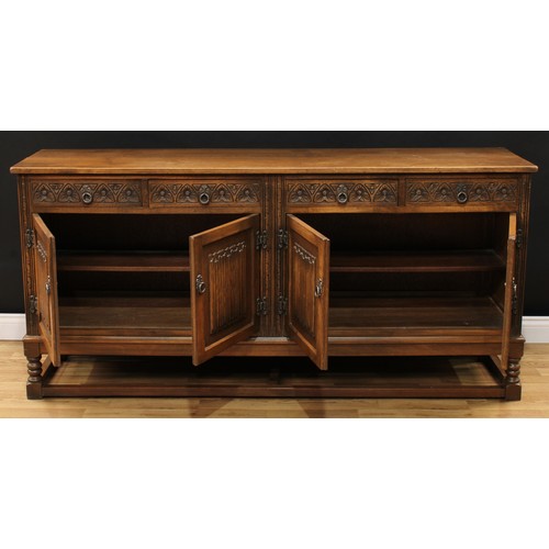 604 - An Old Charm oak low dresser, rectangular top above four frieze drawers and two pairs of linenfold p... 