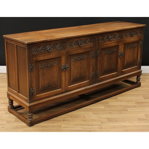 604 - An Old Charm oak low dresser, rectangular top above four frieze drawers and two pairs of linenfold p... 