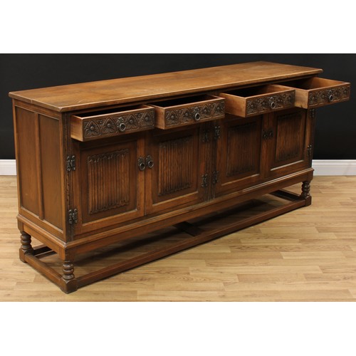 604 - An Old Charm oak low dresser, rectangular top above four frieze drawers and two pairs of linenfold p... 