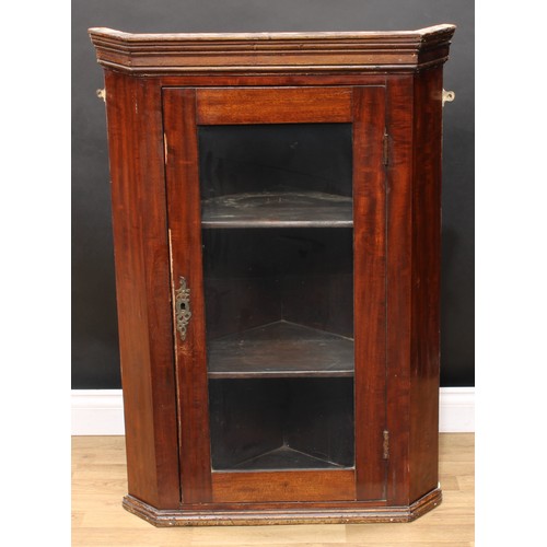 605 - A mahogany corner display cabinet, moulded cornice above a glazed door enclosing two shelves, 107cm ... 