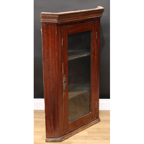 605 - A mahogany corner display cabinet, moulded cornice above a glazed door enclosing two shelves, 107cm ... 