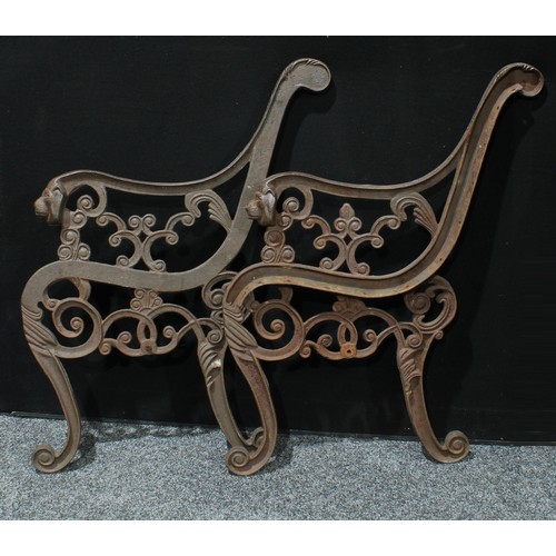 616 - A pair of cast iron garden bench ends, cast with lion masks