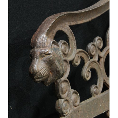 616 - A pair of cast iron garden bench ends, cast with lion masks